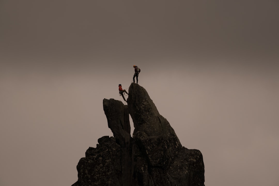 mountaineering safety checklist cover image showing climbers checking gear at dawn near a glacier