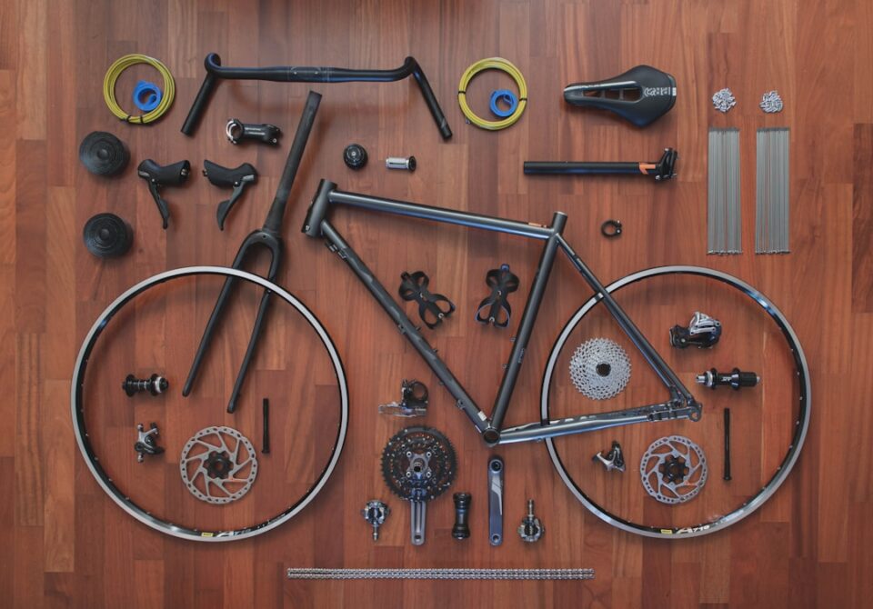 Gravel Bike Maintenance Checklist cover illustration of tools and a gravel bike on a stand