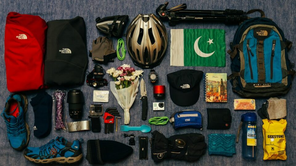 rock climbing gear checklist cover illustration showing helmet, harness, rope, draws, and shoes